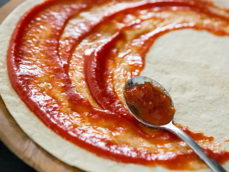 Use fresh tomato sauce on your pizza to cut down on fats and sodium.