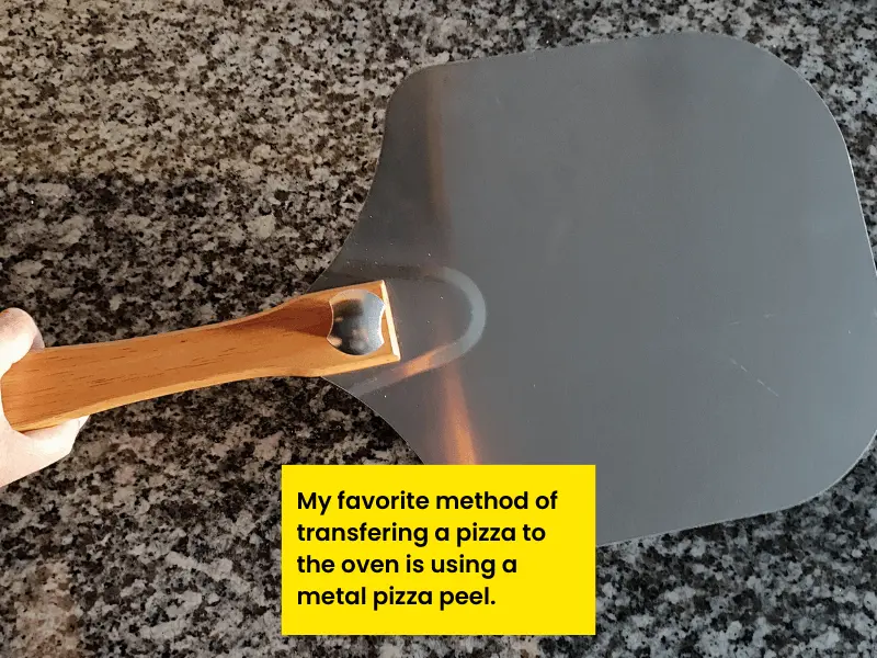 My favorite method of transferring pizza dough to the oven is using a metal pizza peel.